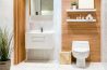 A bathroom with wood paneling and white tile.