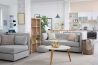 A living room with grey furniture and white walls.