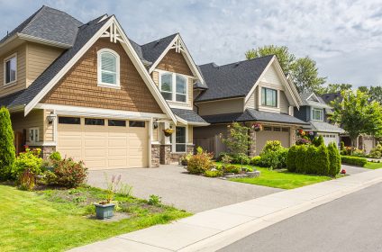 A house with two garage doors and a driveway.