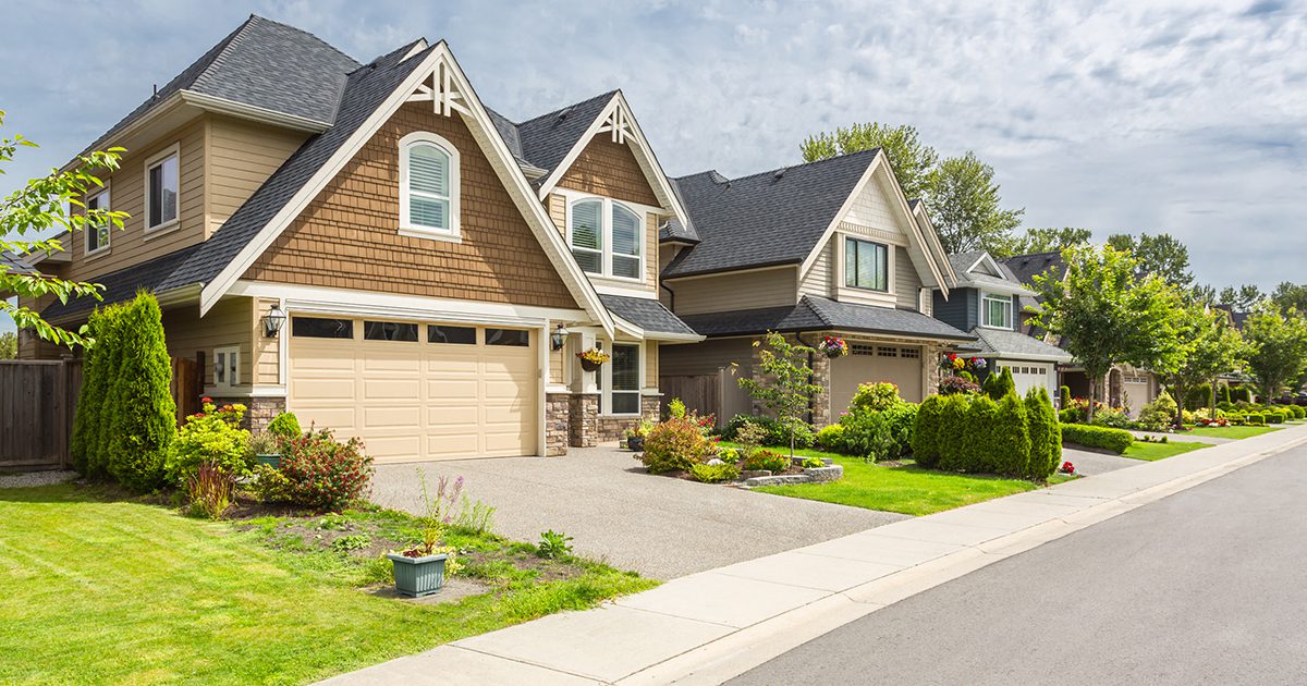 A house with two garage doors and a driveway.