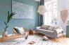 A living room with blue walls and white furniture.